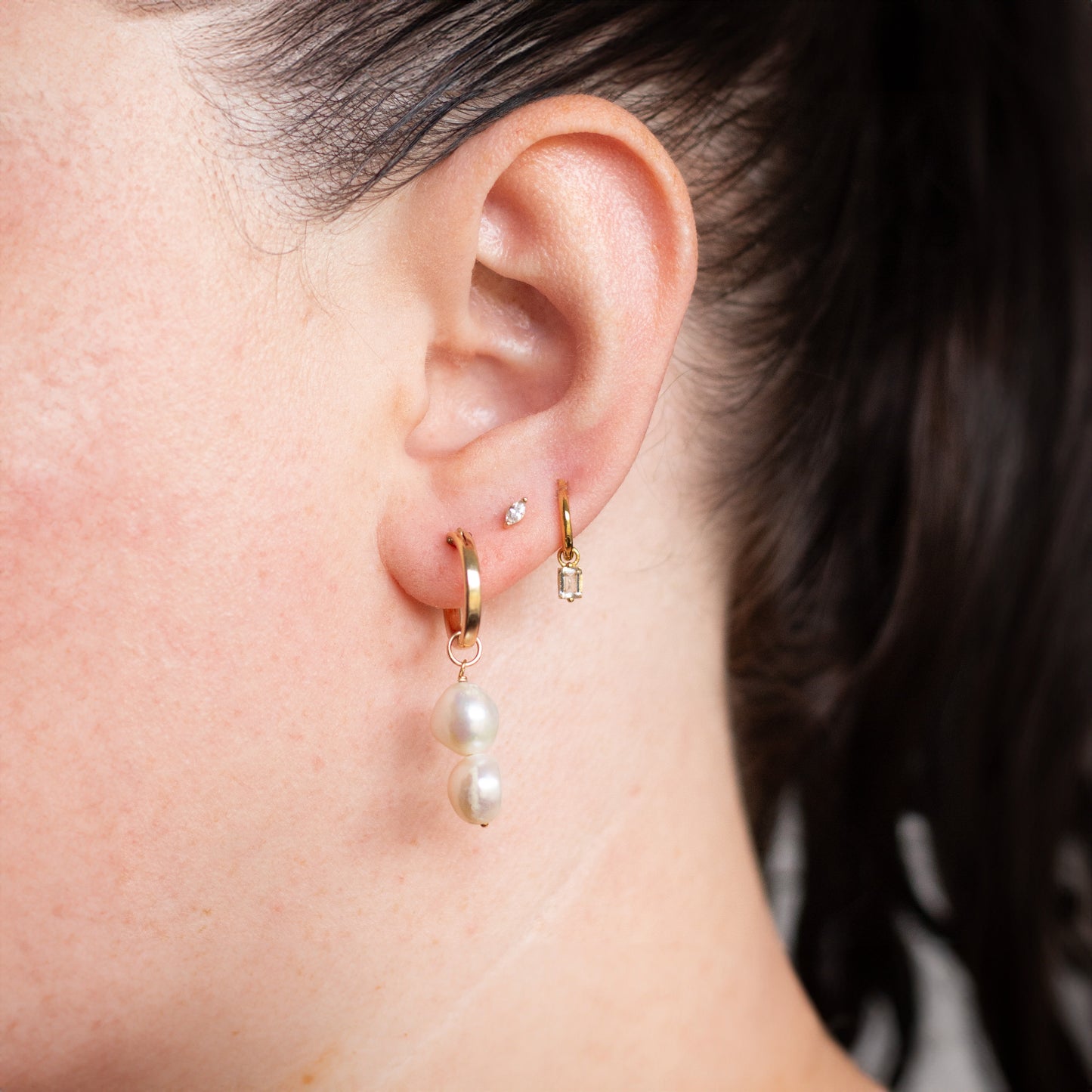Jane wearing her Gia Pearl Hoops in gold filled with a marques stud and white cubic zirconia charm earring