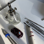 Collection of small tools and objects on a white surface