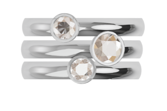 Set of three white gold rings with diamonds on a white background